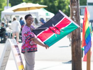 business owner of Spice of Africa with a flag